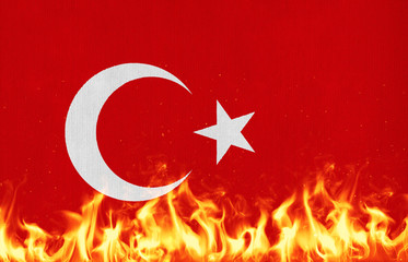 National flag of Turkey on a waving cotton with a fire texture 