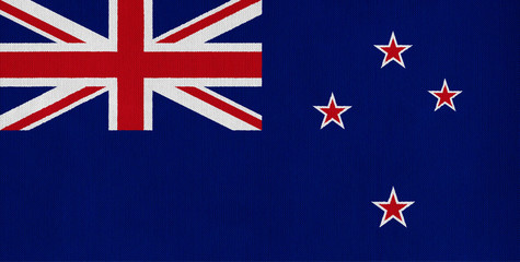 National flag of New Zealand on a cotton texture background