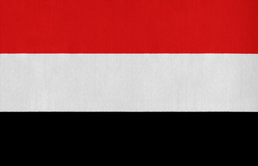 National flag of Yemen on a cotton texture background