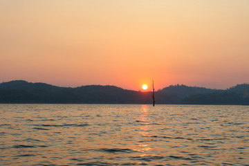 Sunset on reservoir with twilight sky at dusk in Sangkhlaburi, Kanchanaburi, Thailand