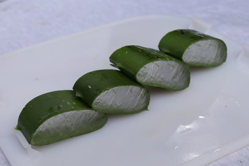Aloe vera pieces of leaf and pulp isolated on a white background