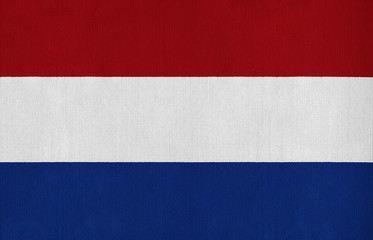 National flag of the Netherlands on a cotton texture background