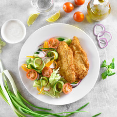 Vegetable salad and breaded chicken breast
