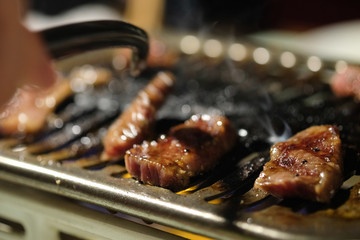 Cooking beef barbecue on grilled stove in restaurant