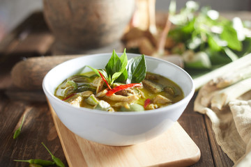 Thai food chicken green curry on wooden background. .