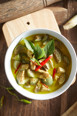 Thai food chicken green curry on wooden background. .