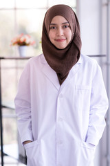 Close Up portrait of muslim female doctor, smiling confident  and looking at camera