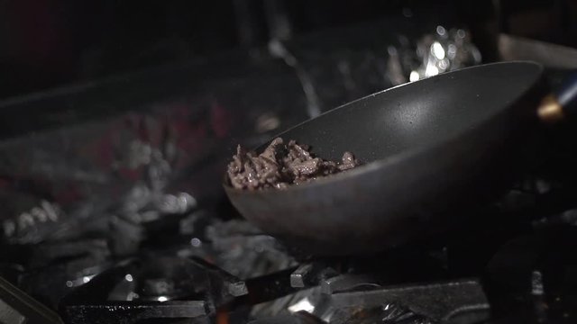 Skillfully cooking red meat in a pan