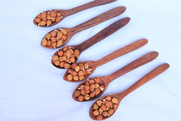 fresh germinated chickpeas with wood spoon on white background