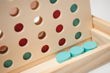Obraz na płótnie Canvas Closeup of mini wooden game with color token alignment