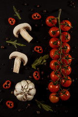 garlic, garlic on a black background with tomatoes and mushrooms