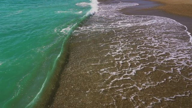 Beautiful sea water splashing at sandy summer beach of Turkey. Slow motion full hd video fooatage.