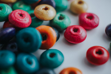 Fototapeta premium colorful wooden beads on a white table
