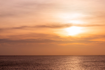 Fototapeta premium Sunset in cloudy sky, evening at sea