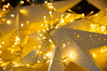 Obraz premium Christmas start with lights background. Nativity star, blurred lights, indoor and outdoor decorations for new year