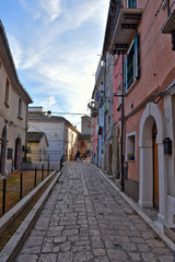 Fototapeta na wymiar Campobasso, Italy, 12/24/2019. A narrow street between the alleys and buildings of a medieval city