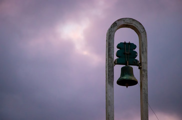 Church bell in a cloudy purple sky