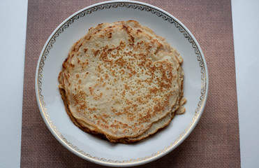 Stack of traditional russian pancakes blini on gray background with copy space. Homemade russian thin pancakes blini. Russian food, russian kitchen