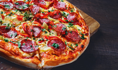 Pepperoni Pizza with Mozzarella cheese, salami, pepper. Spices and Fresh basil. Italian pizza on...