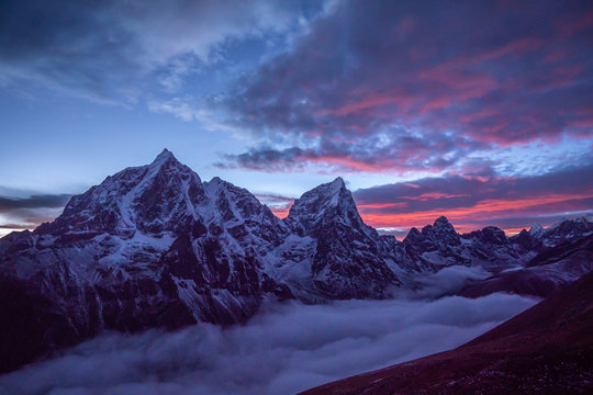 Taboche and Cholatse mountains at Sunset. Himalaya, Nepal. Pink Sky with Clouds