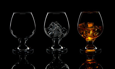 set of empty whiskey glass, with ice and whiskey