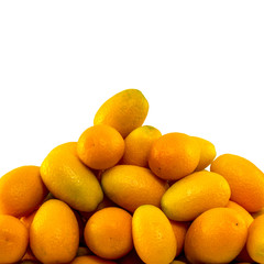 Heap of kumquat fruits. Close-up. Isolated on white background with copy space.