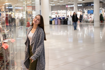 Shopping A young girl in a mall enjoys a sale and discounts.