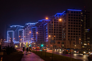 Fototapeta na wymiar Glowing buildings at night. Illumination back Christmas and New Year. Minsk, Belarus. December 24, 2019