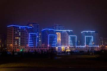 Fototapeta na wymiar Glowing buildings at night. Illumination back Christmas and New Year. Minsk, Belarus. December 24, 2019