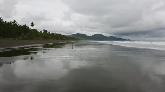 Aerial flies close over the beach and flying high up in Nuqui, Colombia.