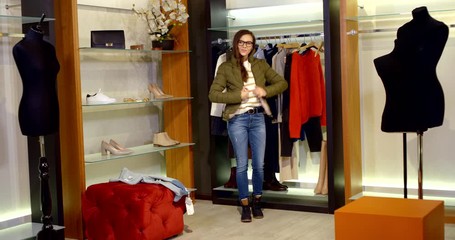Stylish young girl with glasses will try clothes in the store, Shopping in the supermarket