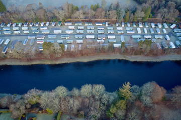 Aerial view of caravan park from above in countryside rural area by river