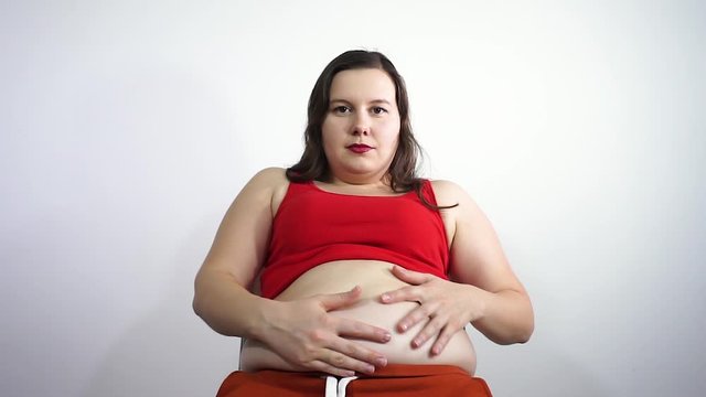 The girl strokes his fat belly and smiling.Body positive