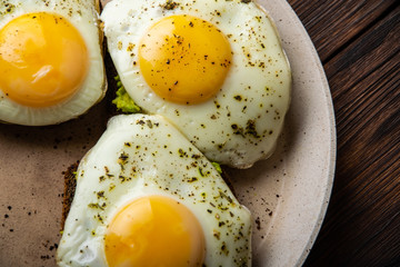 delicious sandwiches with egg and avocado in a pan close-up