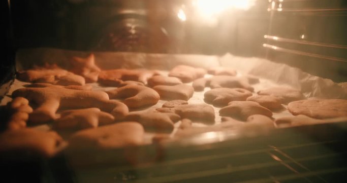 Time lapse of freshly made cookie dough rising up and expanding inside the hot oven
