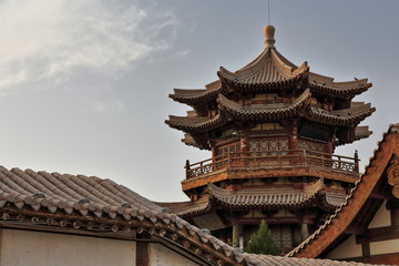 Fototapeta na wymiar Upper upturned eaves-Chinese pagoda and surrounding pavilions overlooking Crescent Lake.Dunhuang-Gansu-China-0664