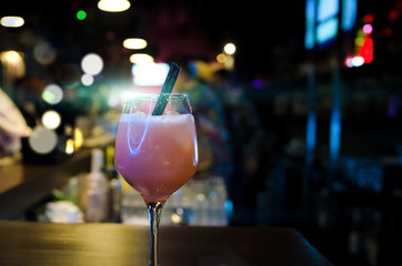 Fresh pink cocktail. Nightclub background
