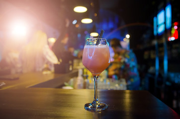 Fresh pink cocktail. Pub background