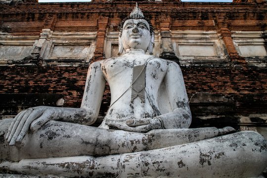 single Buddha statue inside Wat Yai Chai Mongkhon, a Buddhist temple of archaeological park, Ayutthaya, Thailand