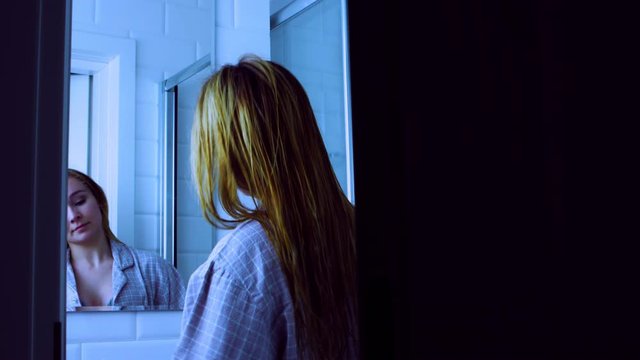 Peeping young woman while she is underssing in bathroom. Disturbed her privacy.