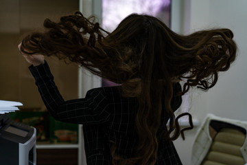 Fototapeta na wymiar Girl dissolve her long hair