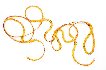 Gold ribbon from sequins for decorating gifts on a white background