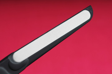 black metal lazer nail file manicure on bright pink background
