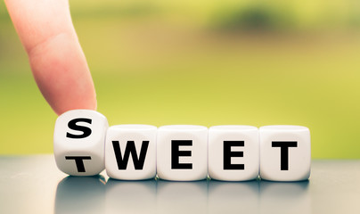 Hand turns a dice and changes the word "sweet" to "tweet".