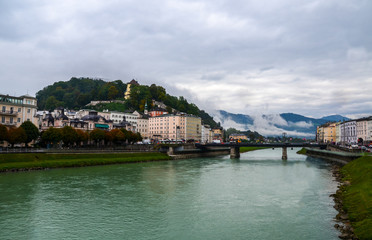 Fototapeta na wymiar Wiew of the rainy Salzburg and Salzach river. Austria