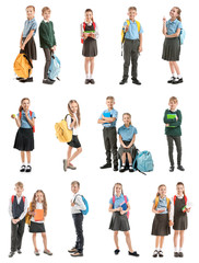 Collage with cute little pupils in different school uniforms on white background