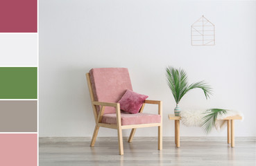 Armchair and table with floral decor near light wall