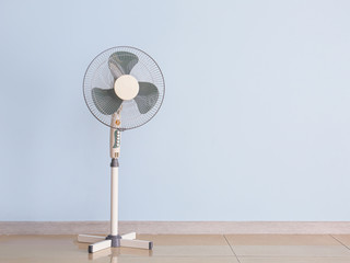 Modern electric fan near color wall