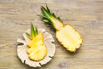 Fresh cut pineapple on wooden background