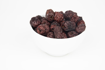 Dried Red Jujube Fruit (Dried Red Dates)  in white bowl on white background